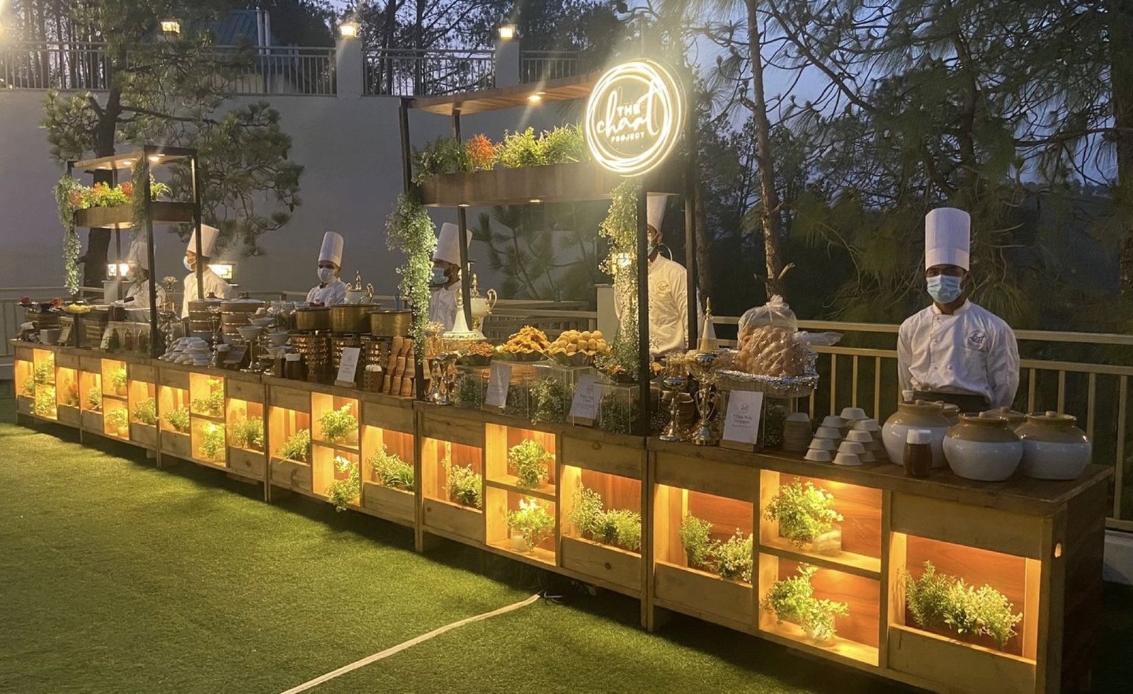 Live counters at twilight beneath the Chaat Project neon sign